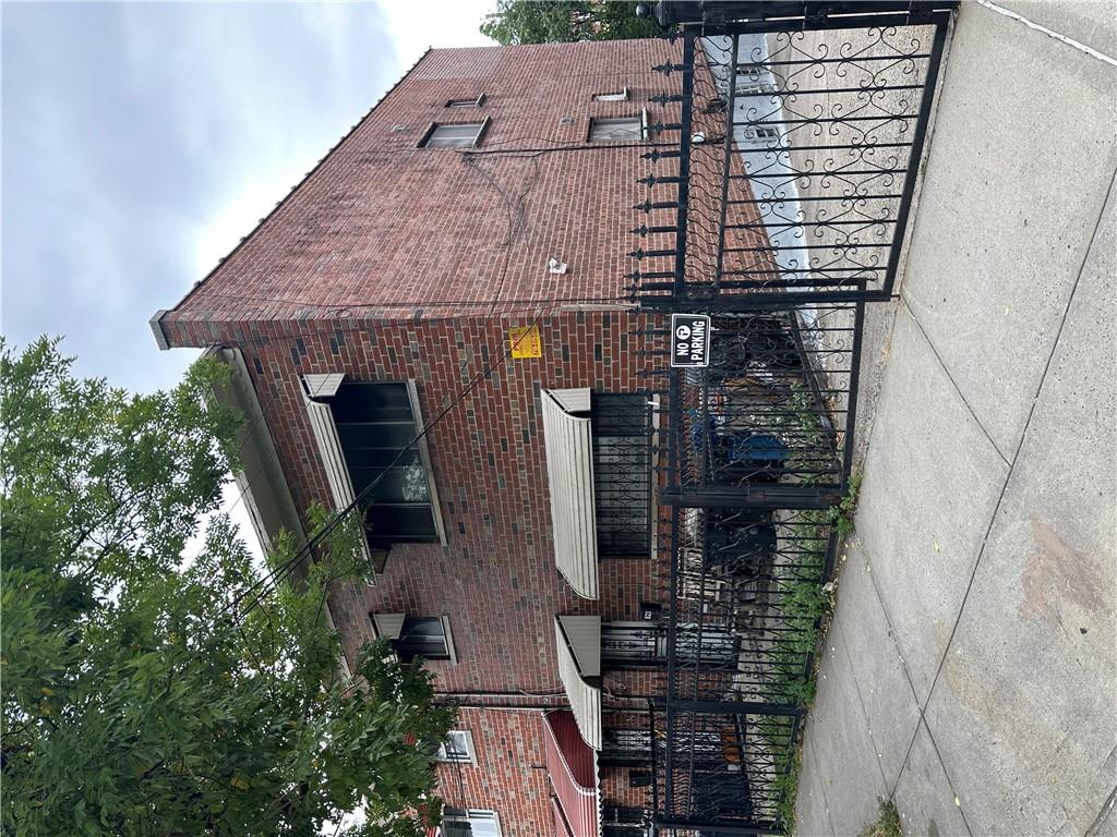 a view of brick house with large windows