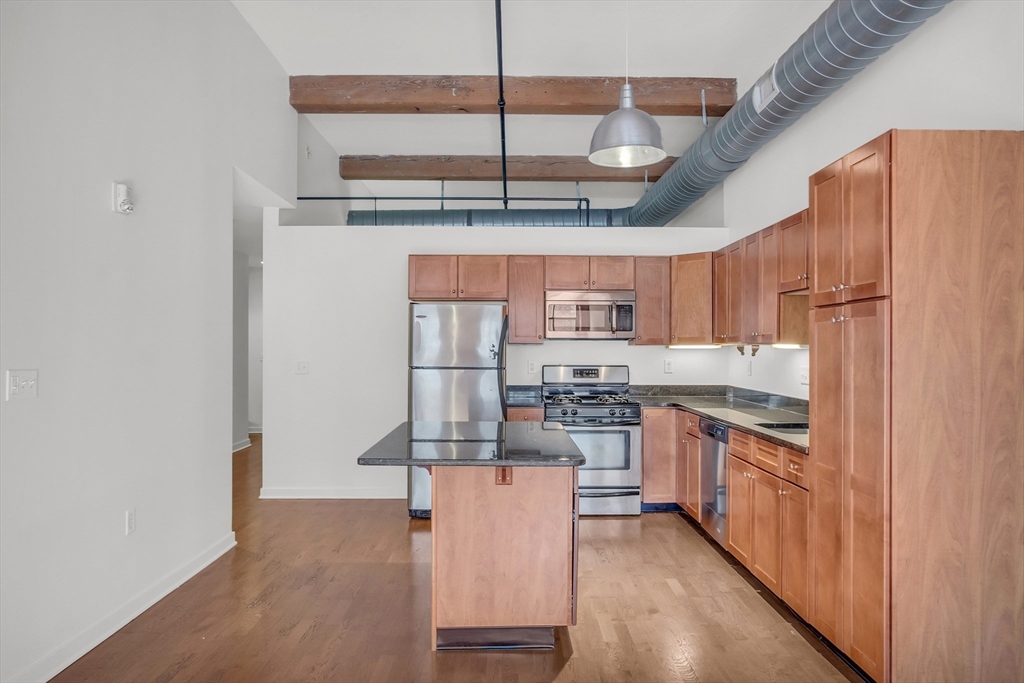 a kitchen with stainless steel appliances granite countertop a sink and cabinets