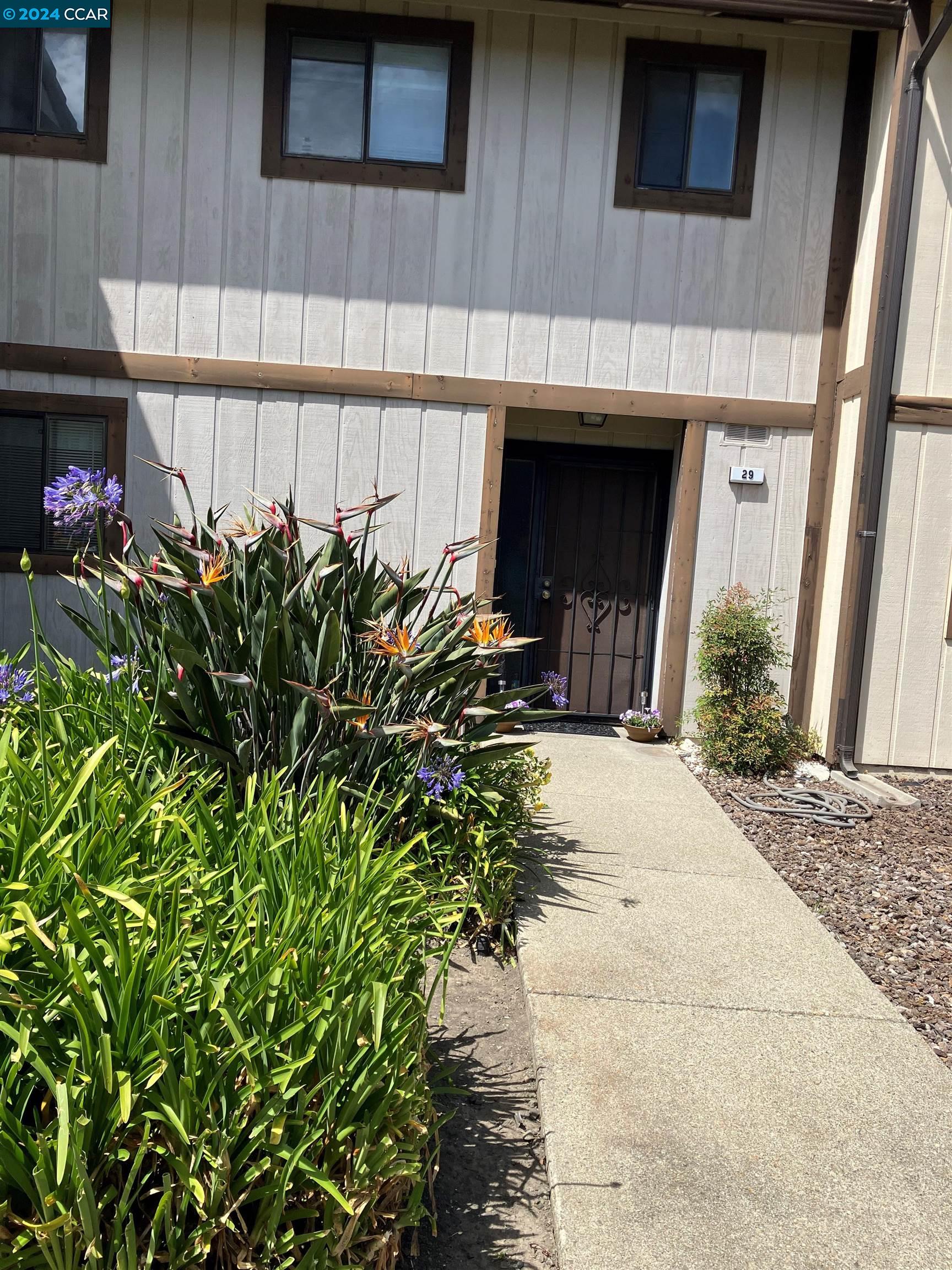 a front view of a house with garden