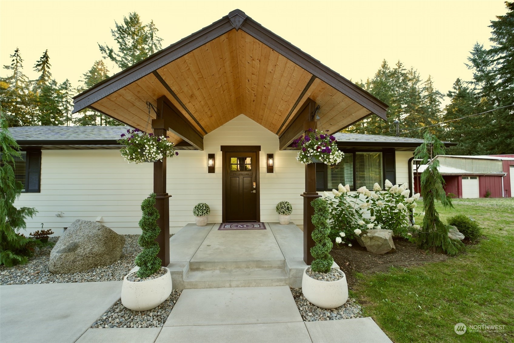 a front view of a house with a garden