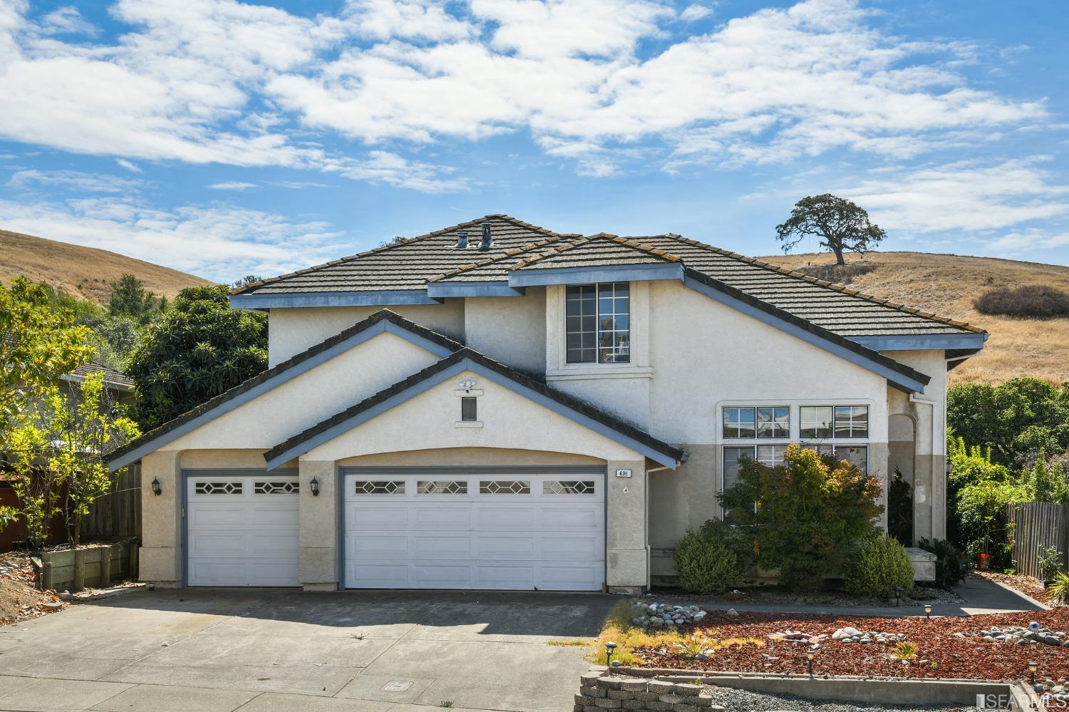 a front view of a house with a garden