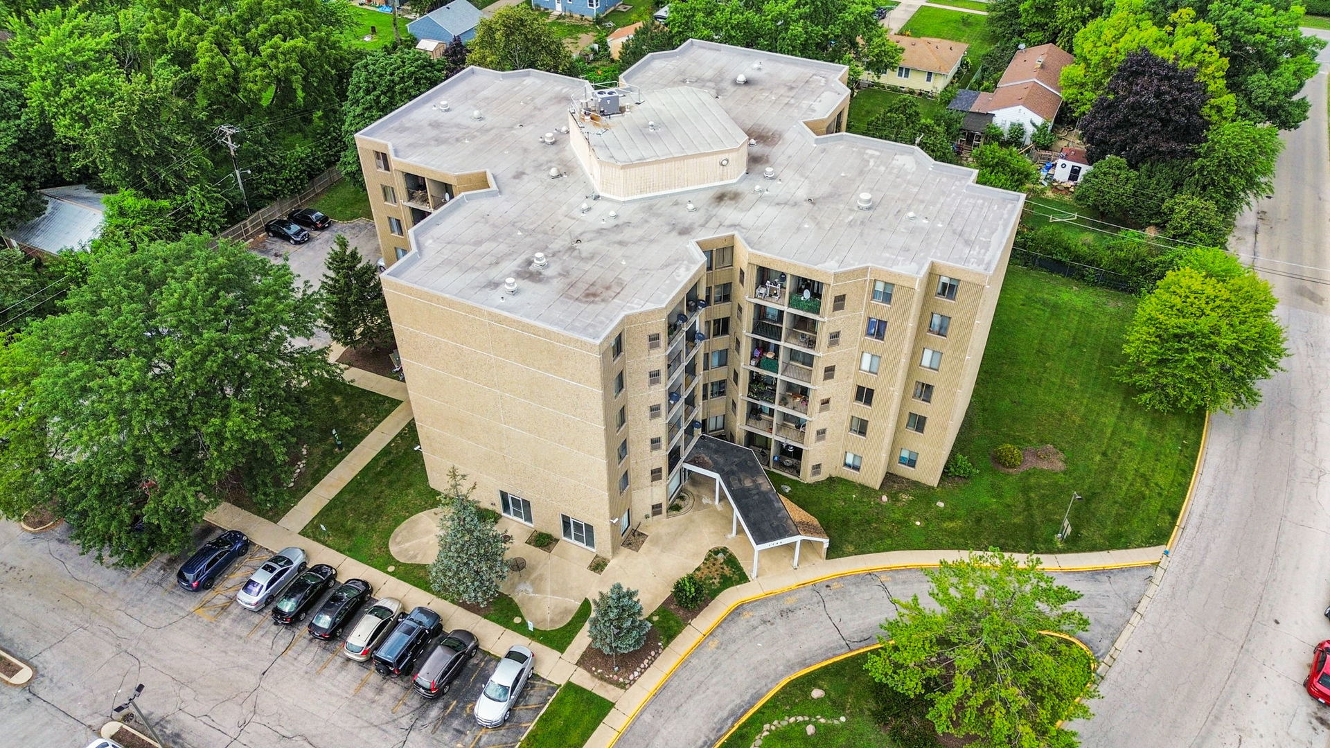 an aerial view of a house with a yard and trees