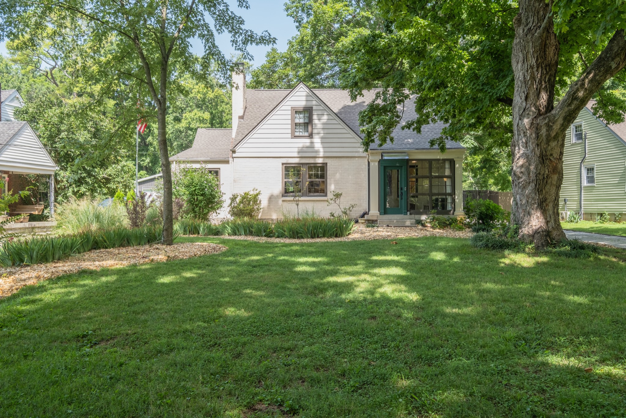 a view of a house with a yard and sitting area