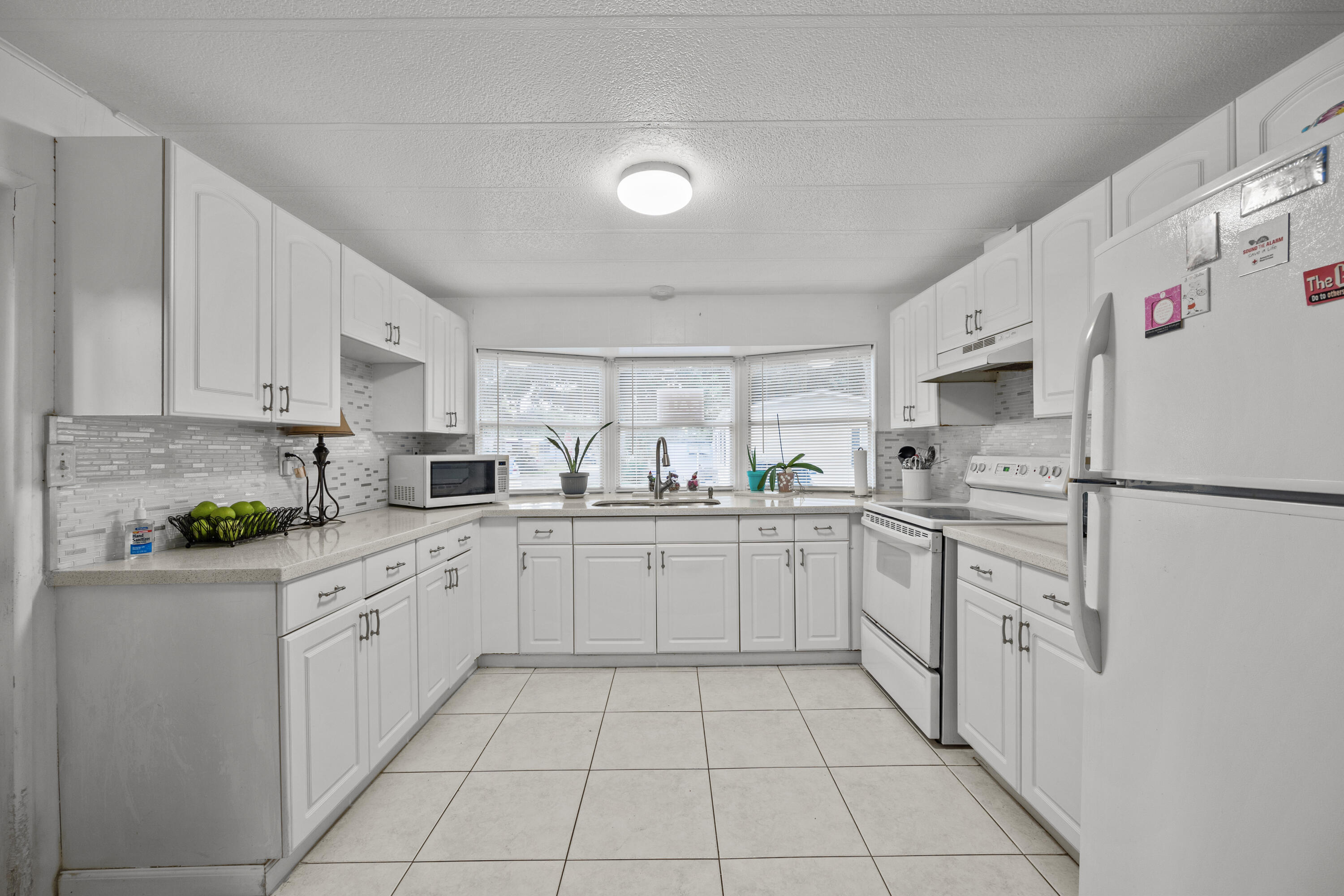 a kitchen with white cabinets stainless steel appliances and sink