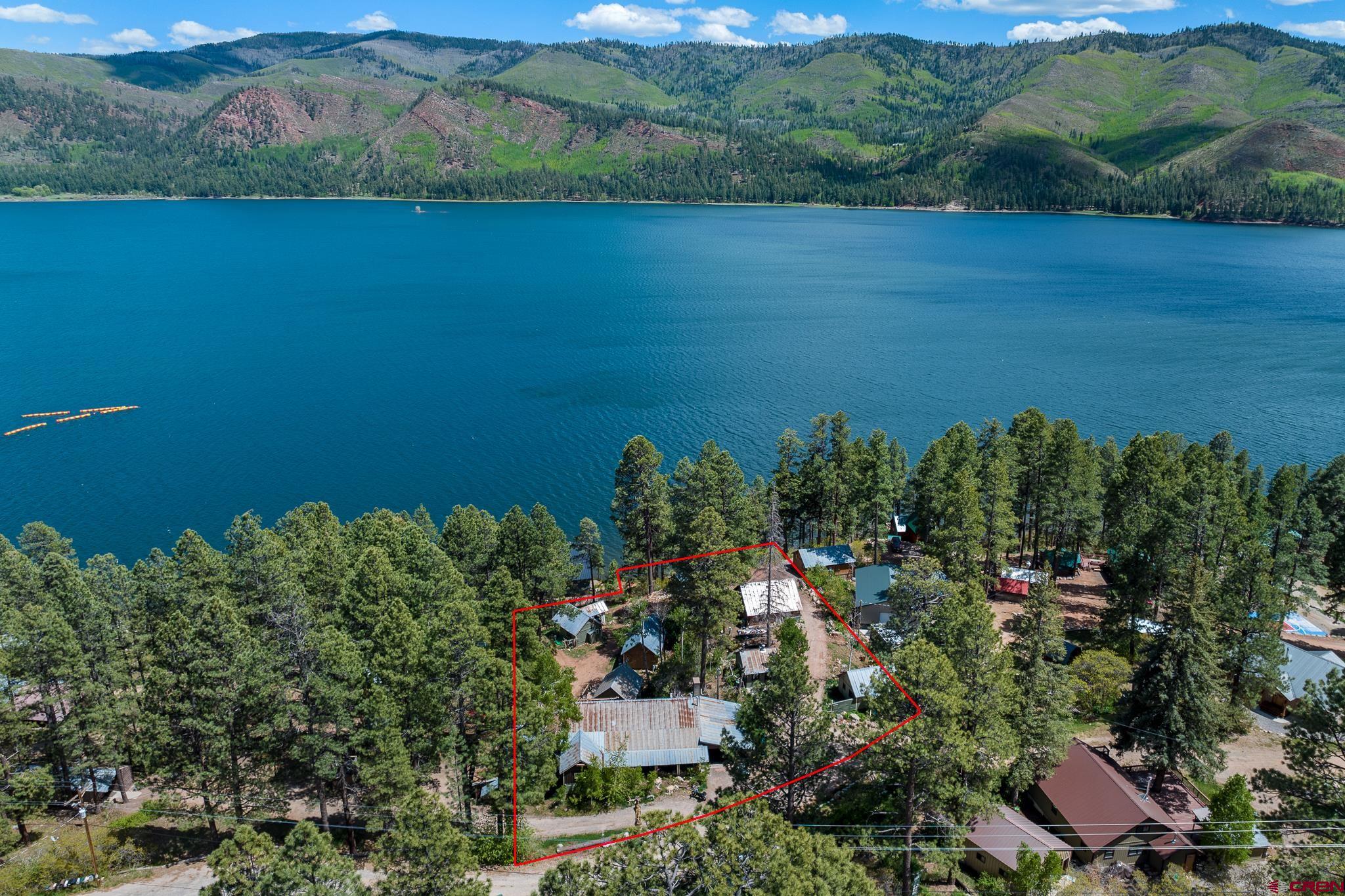 an aerial view of a houses with a yard