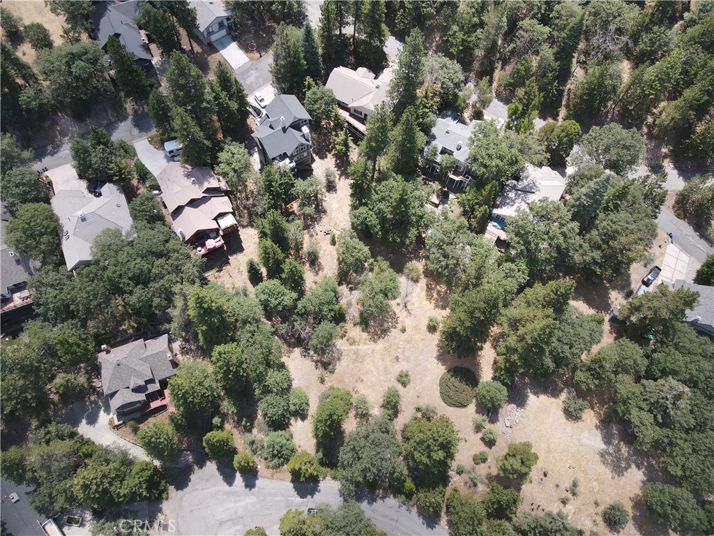 an aerial view of multiple houses with yard