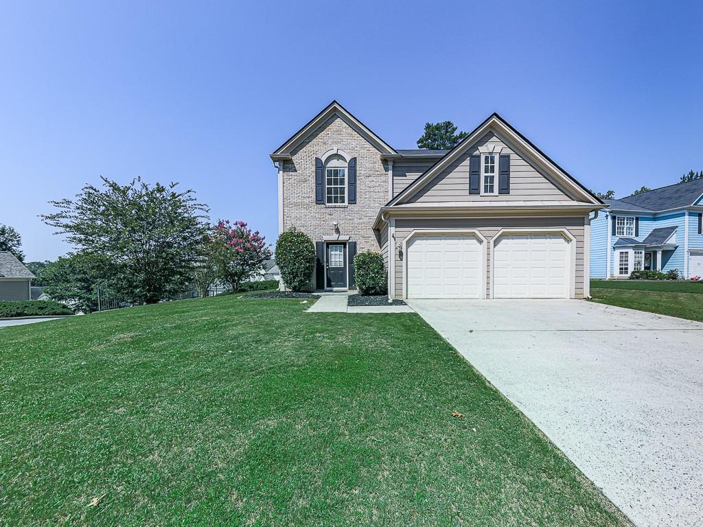 a front view of a house with a yard