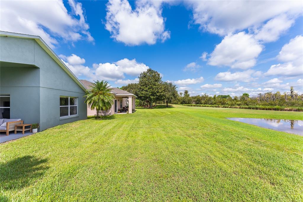 a front view of house with yard and ocean