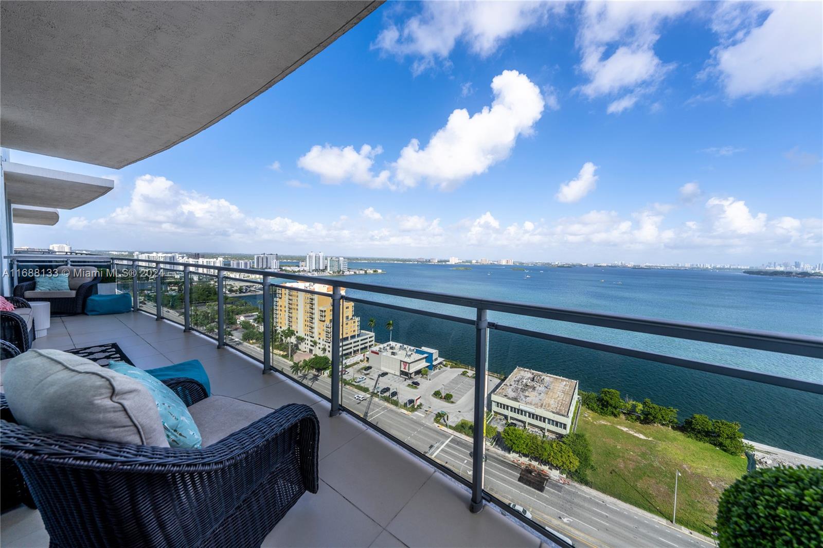 a view of a balcony with swimming pool and furniture