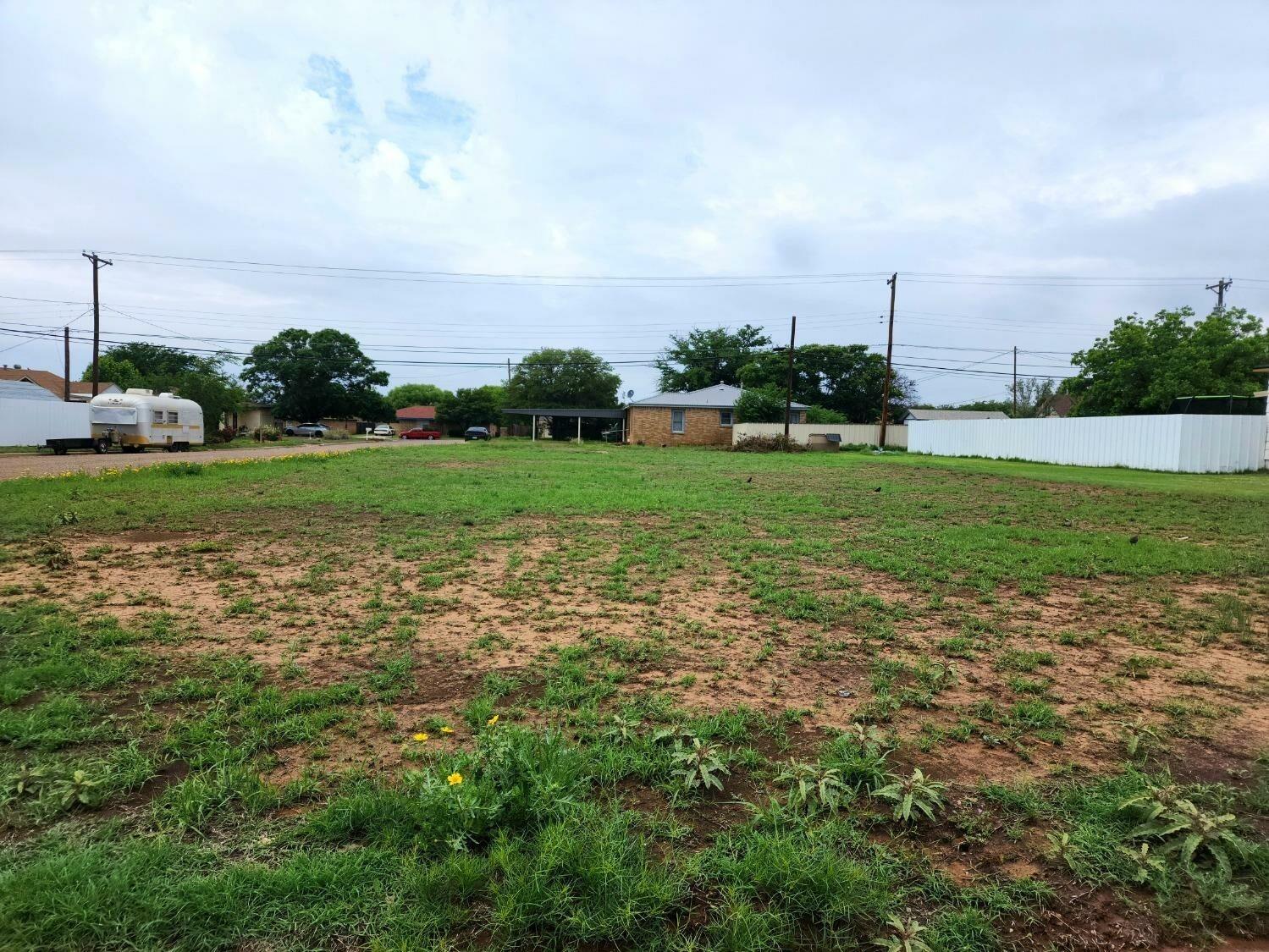 a view of a garden with a building in the background