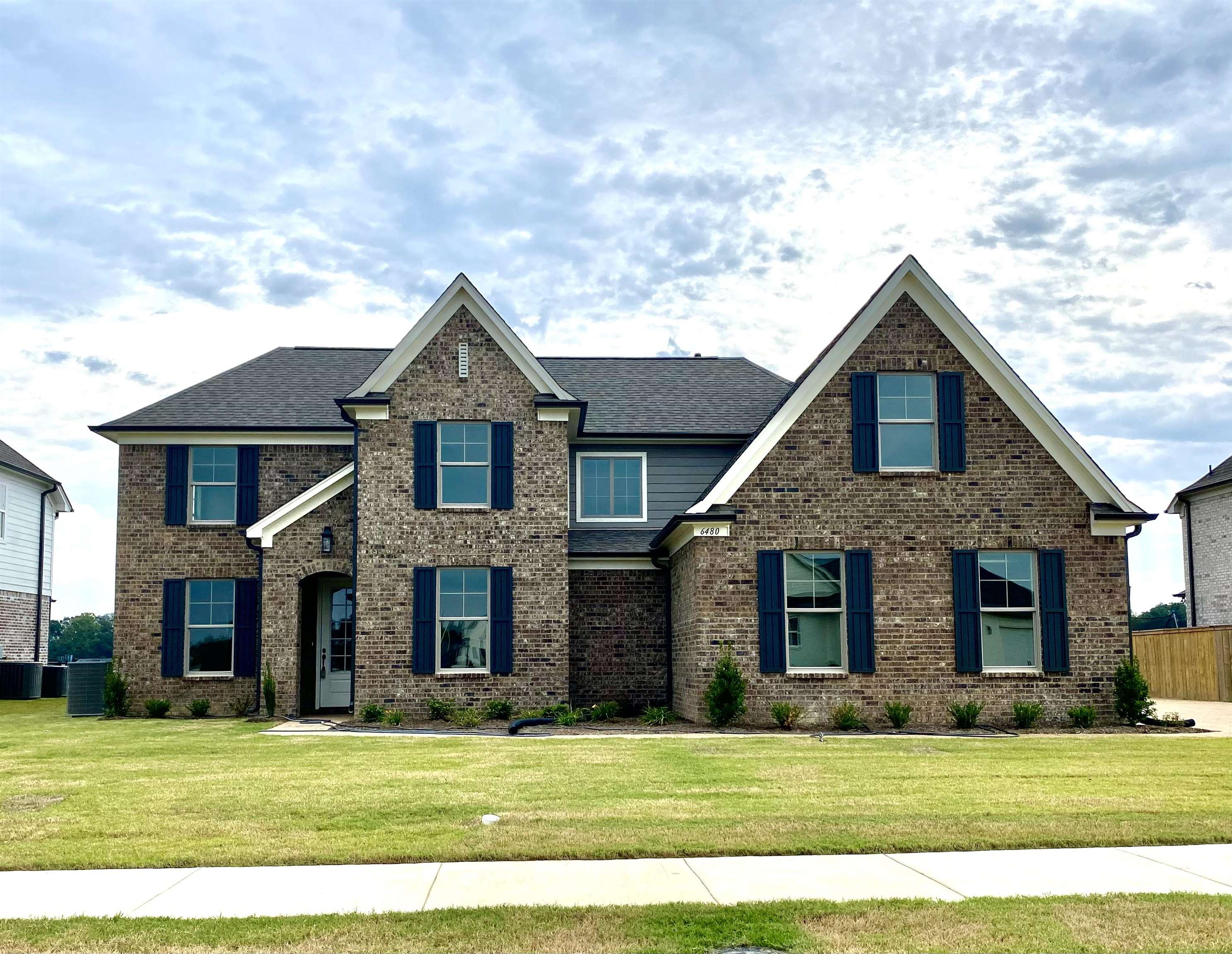 Craftsman house with central AC unit and a front yard