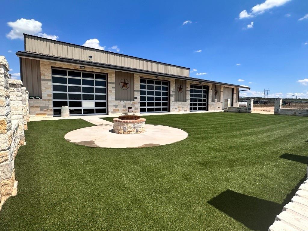 a view of a house with backyard and sitting area