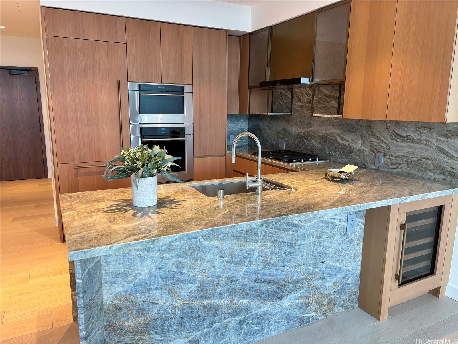 a kitchen with granite countertop a sink and a stove top oven