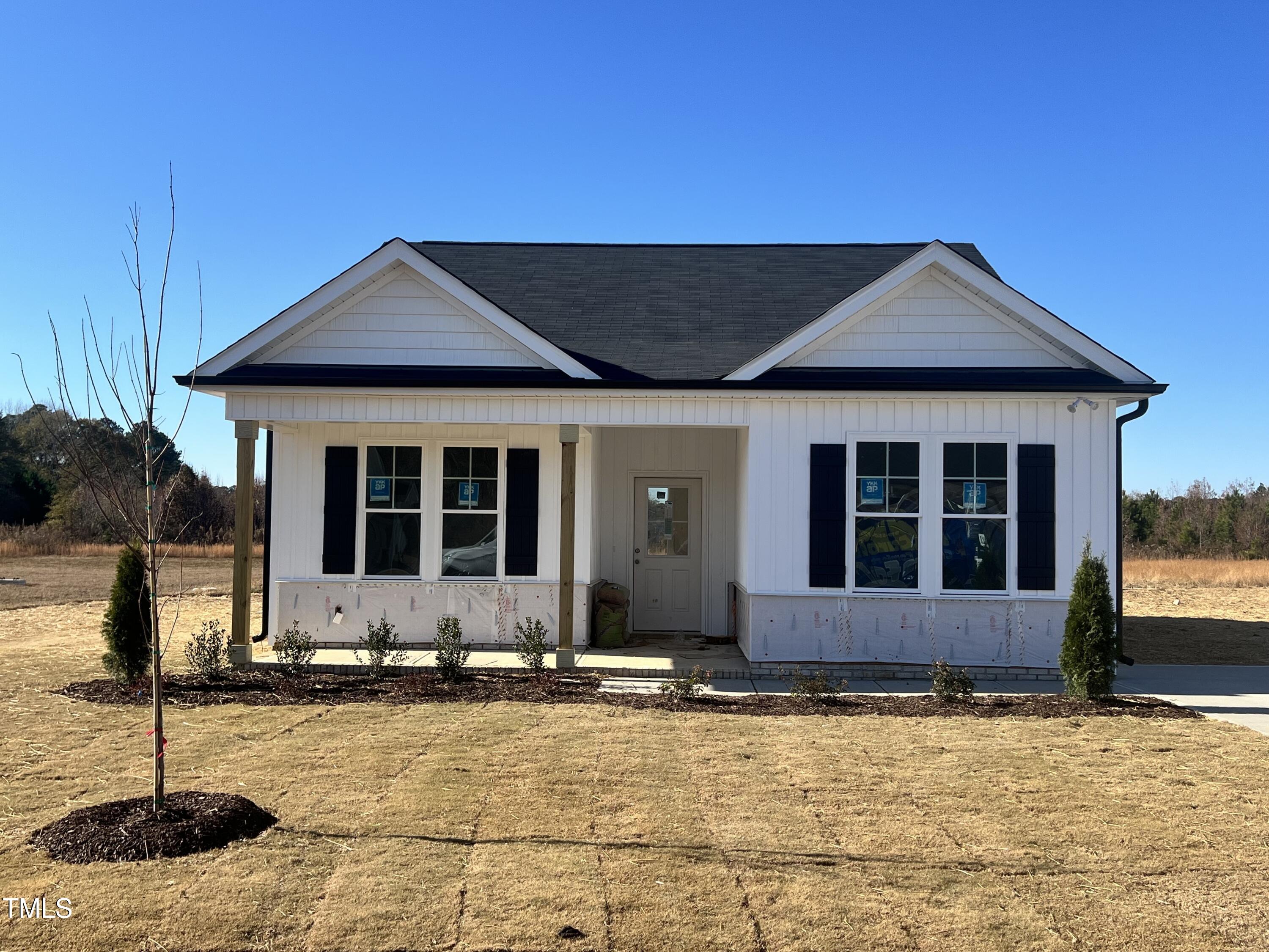 a front view of a house with yard and parking space