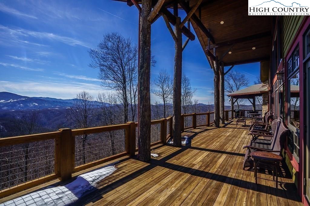 a view of balcony with wooden floor and fence