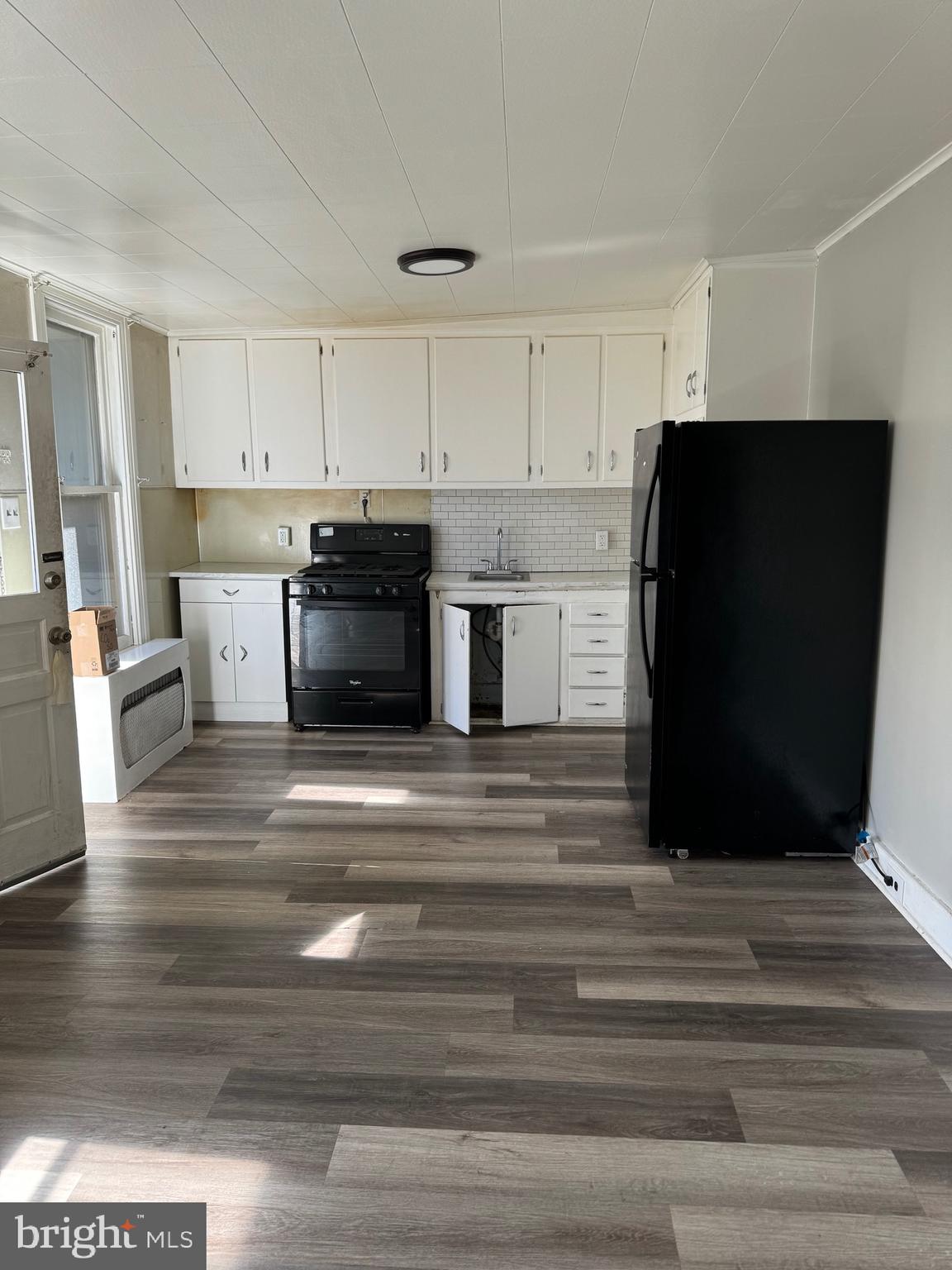 a kitchen with a refrigerator and a stove