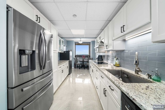 a large kitchen with a stove and refrigerator