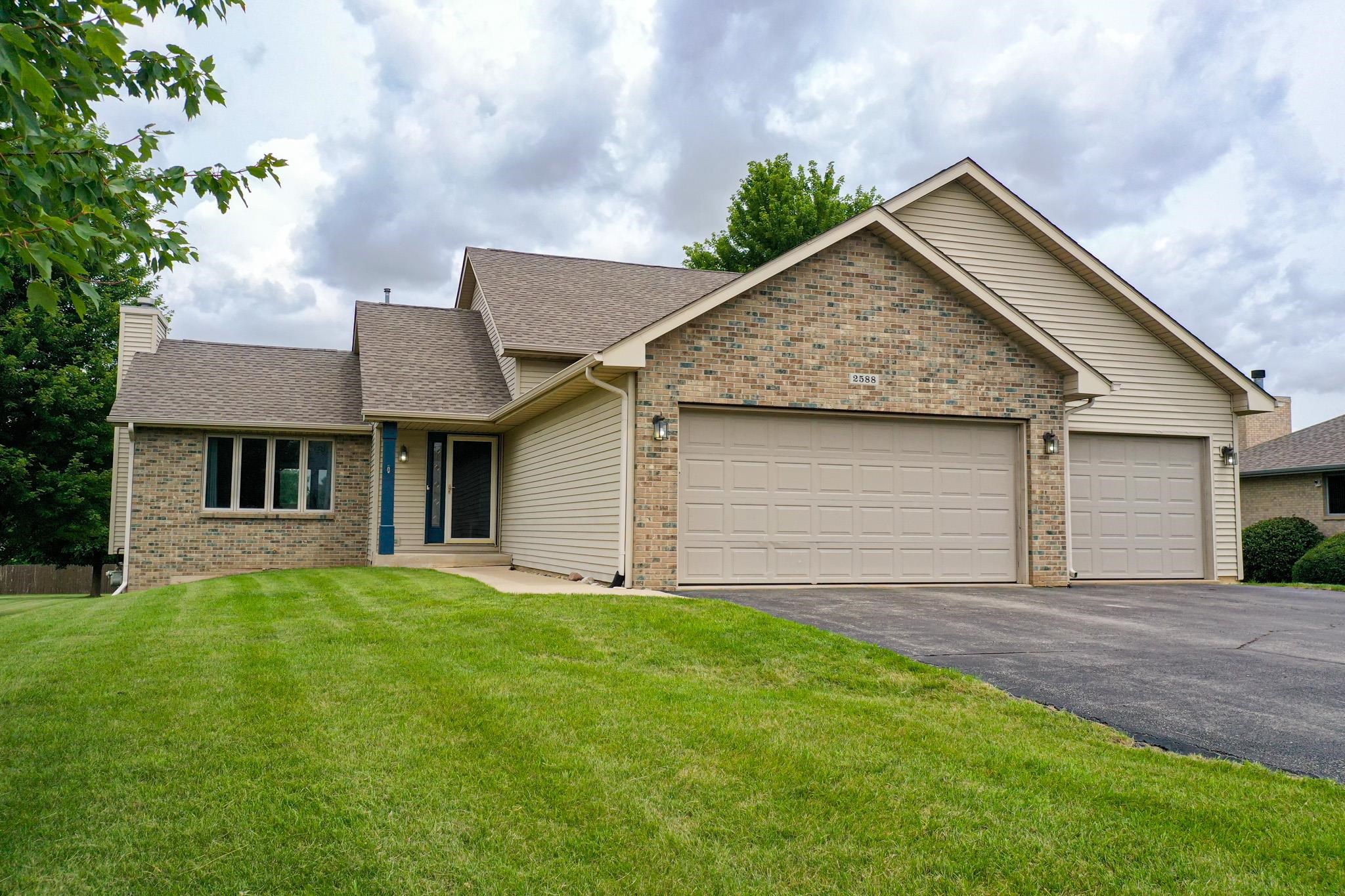 a front view of a house with a yard and garage