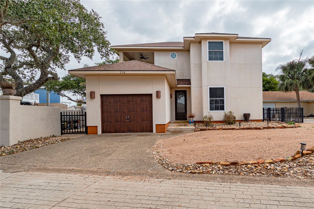 a view of a house with a yard and garage