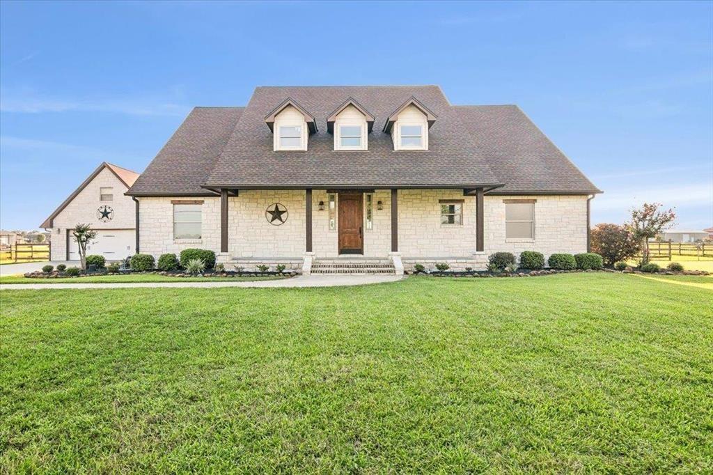 a front view of house with yard and seating space