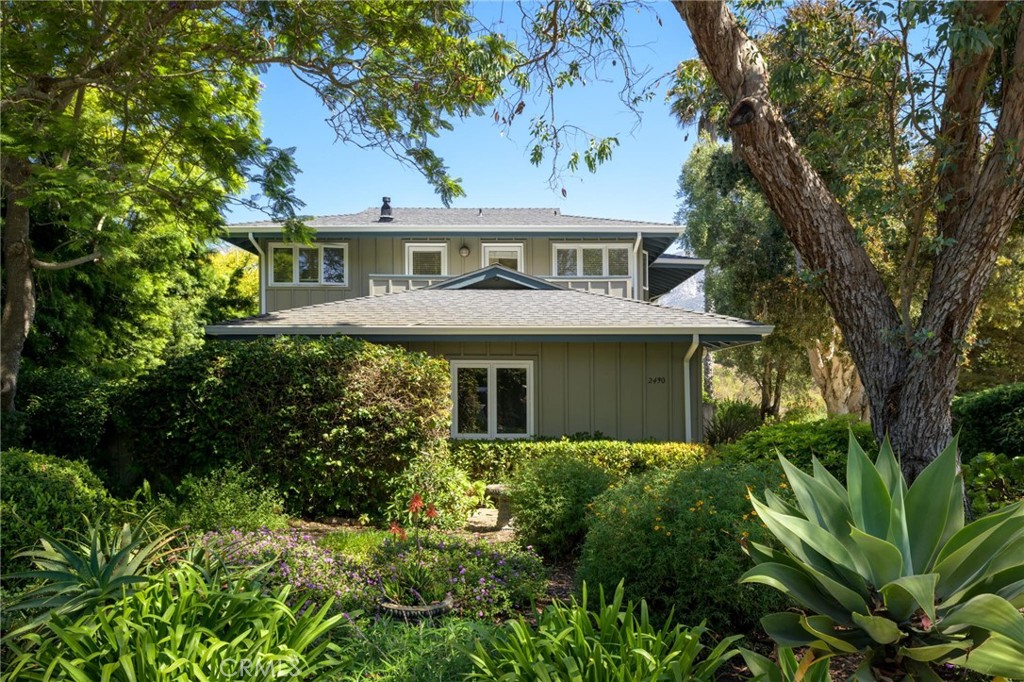 a front view of a house with a garden