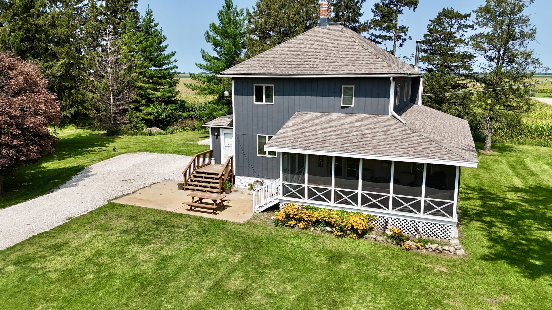 a view of a house with a yard and sitting area