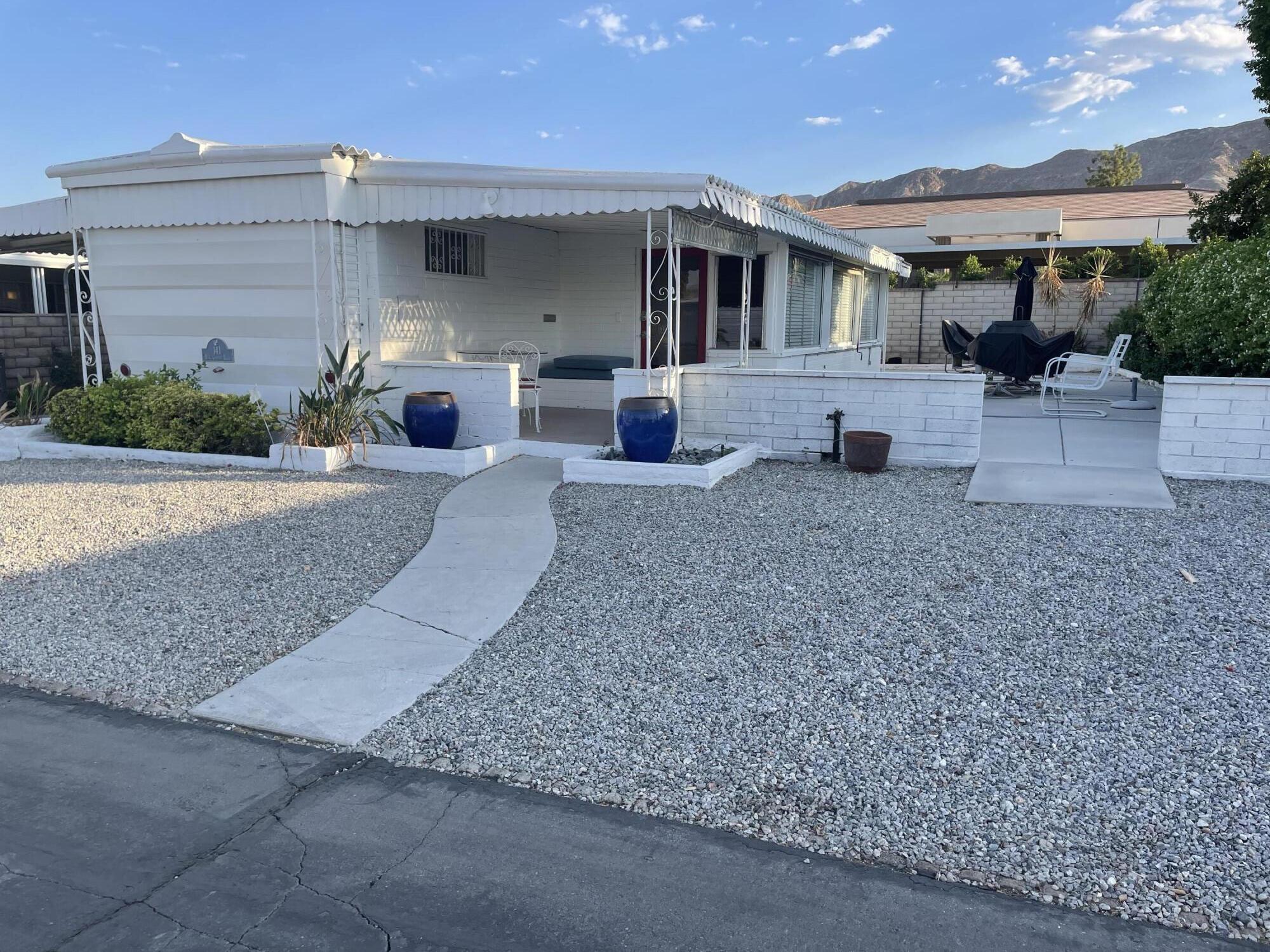 a front view of a house with a yard and a garage