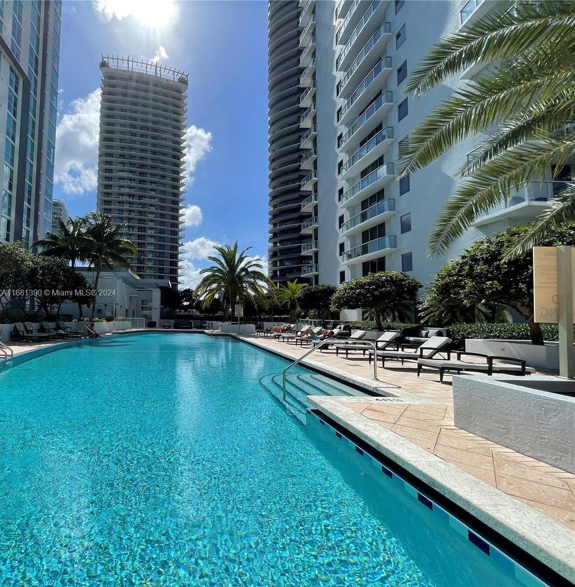 a view of a swimming pool with outdoor seating