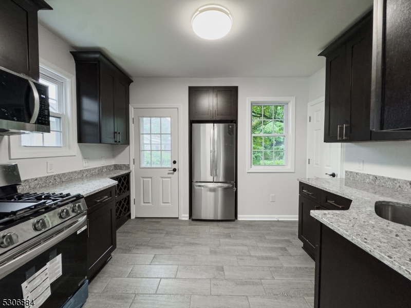 a kitchen with a stove a sink and a microwave