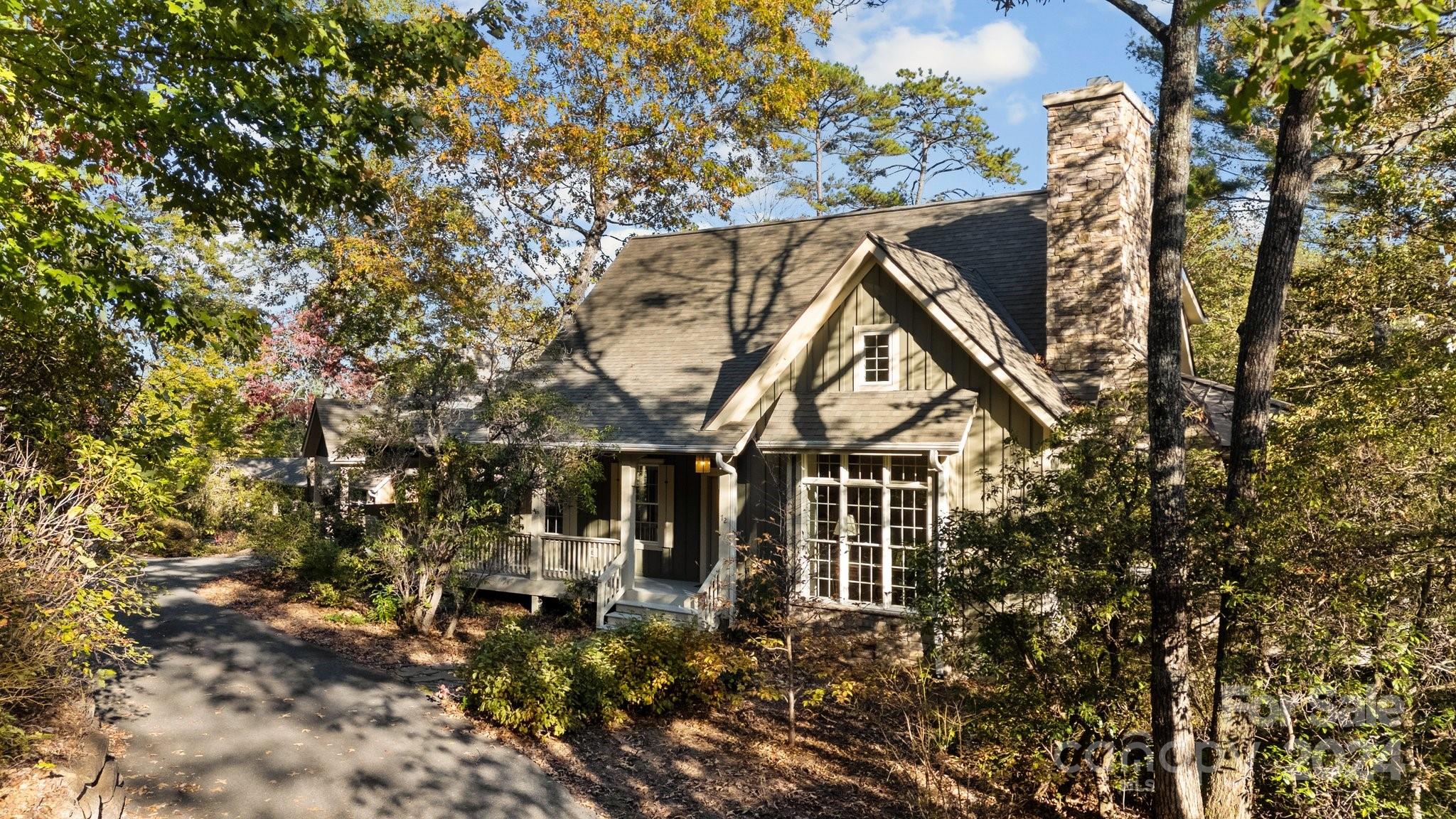 front view of a house with a tree