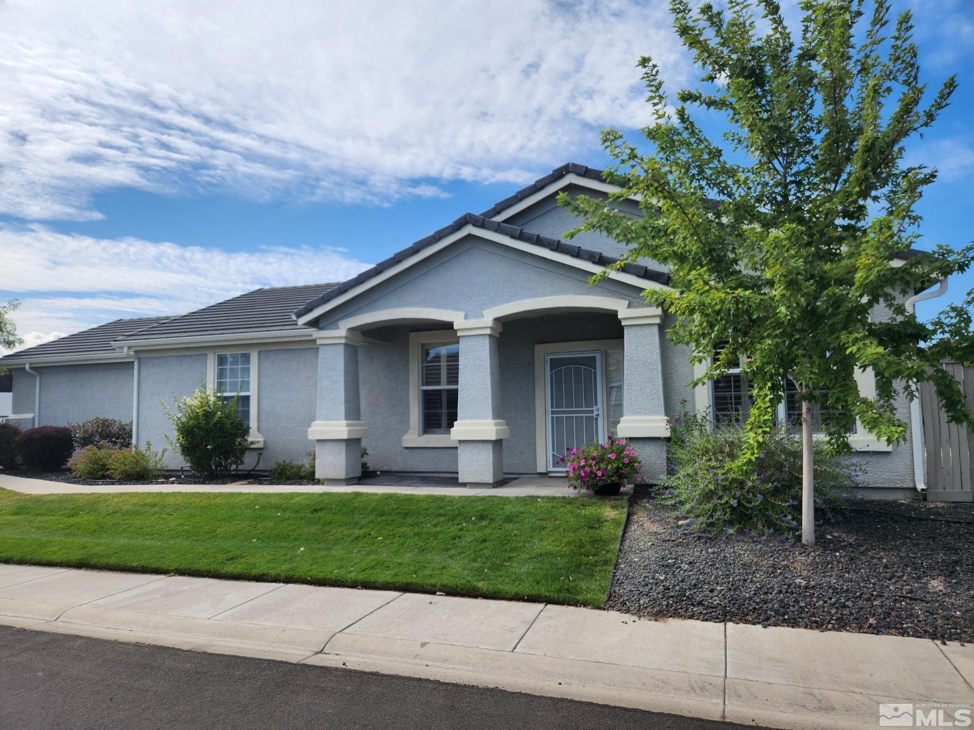 a front view of a house with a yard and a garage