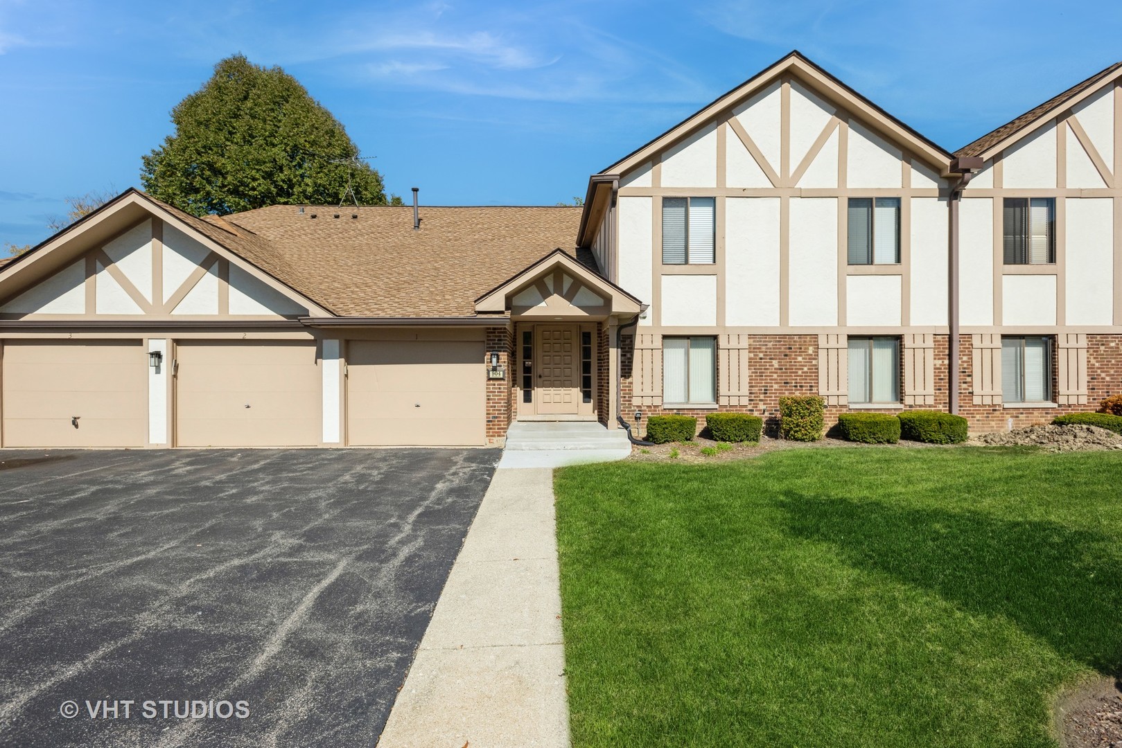 a front view of a house with a yard and garage