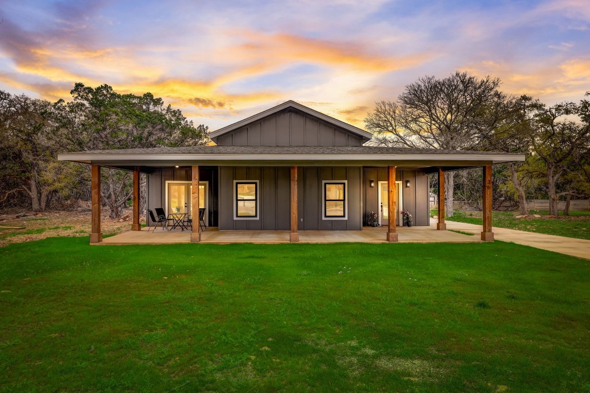 a front view of a house with yard patio and green space