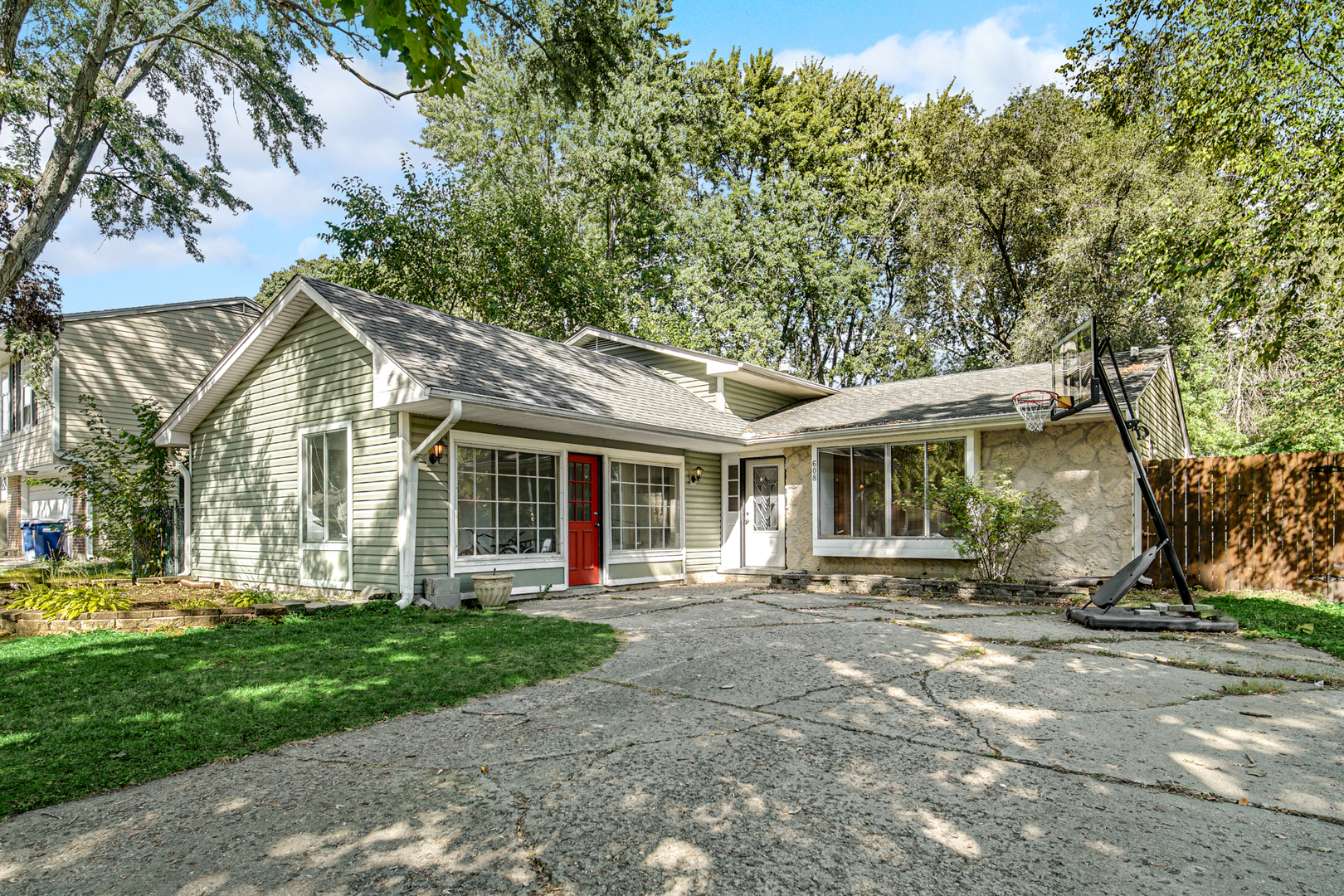 a front view of a house with a garden