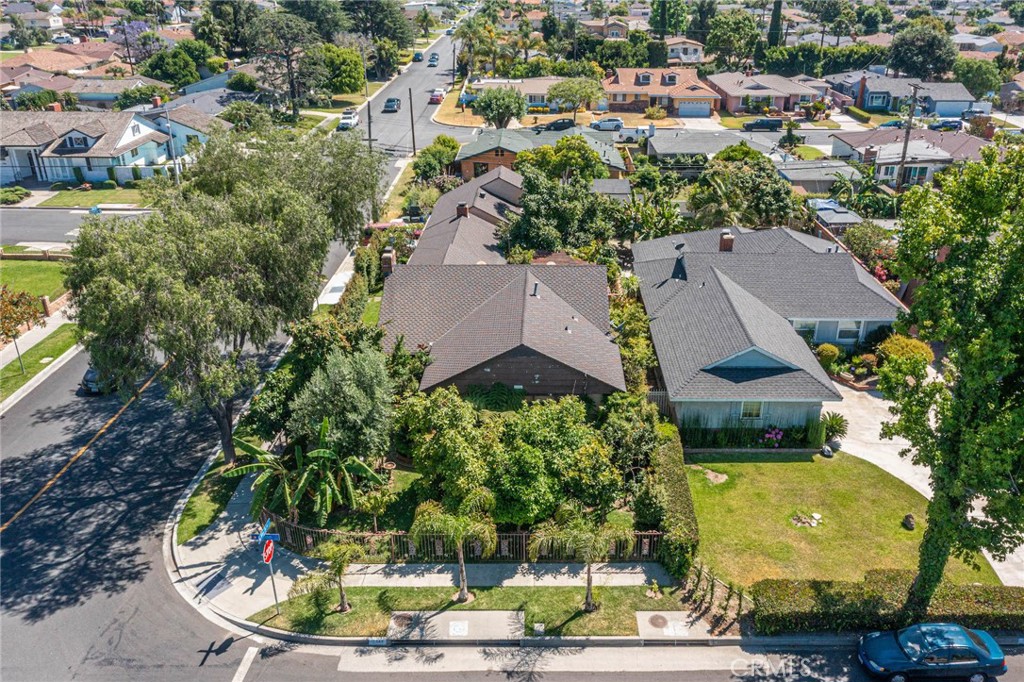 an aerial view of a house with a yard basket ball court and outdoor seating