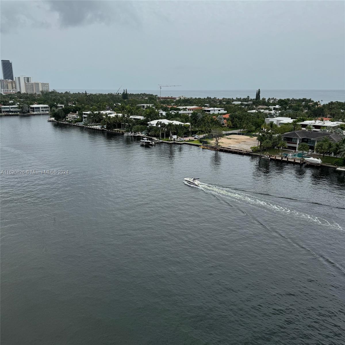 an aerial view of a houses with boats and trees