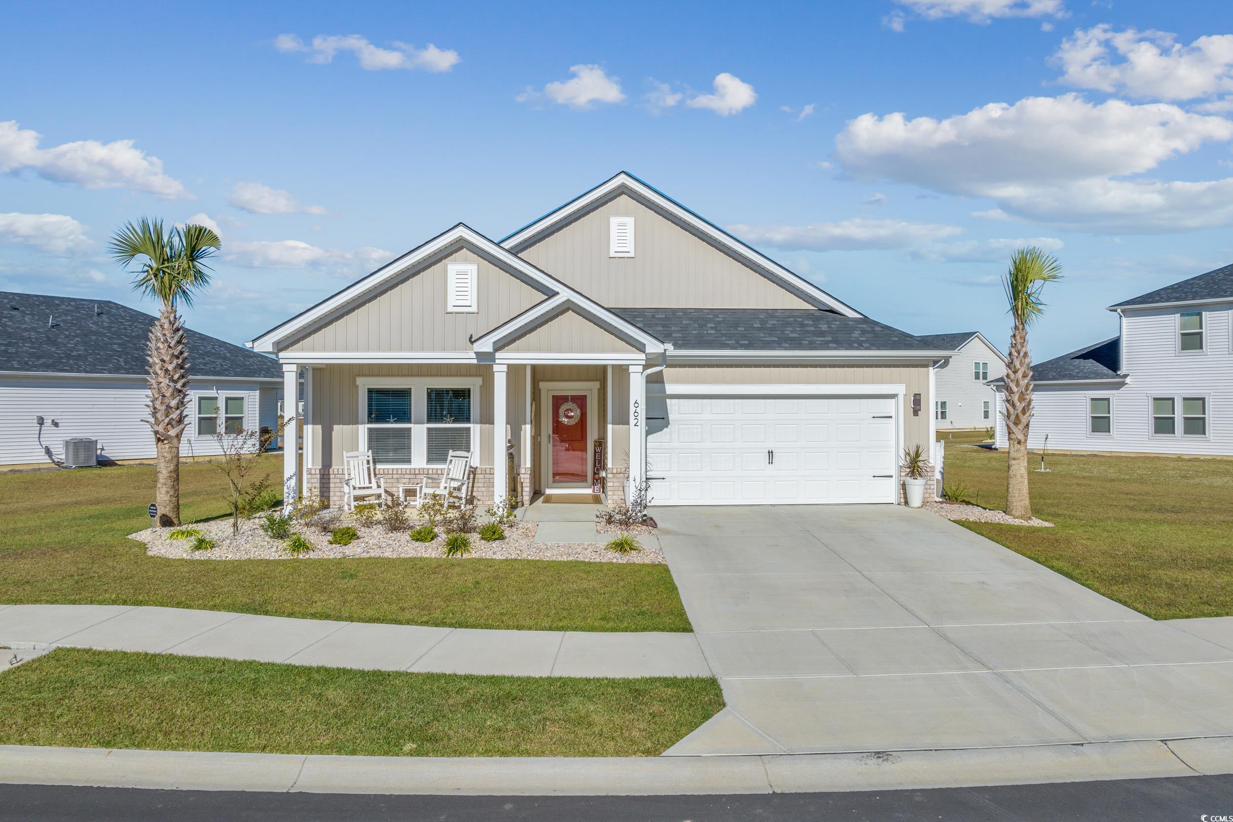 Craftsman-style home with a front yard, central AC