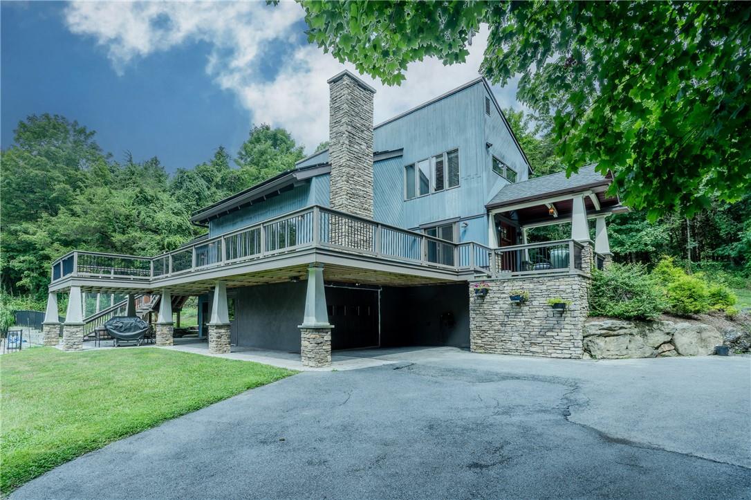 View of side of home with a yard