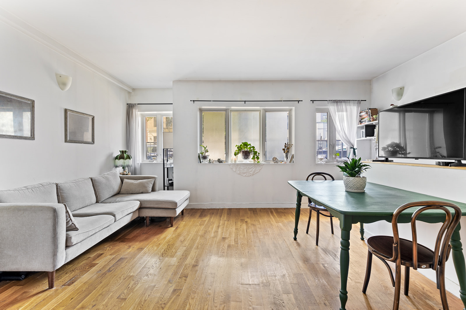 a living room with furniture and a wooden floor