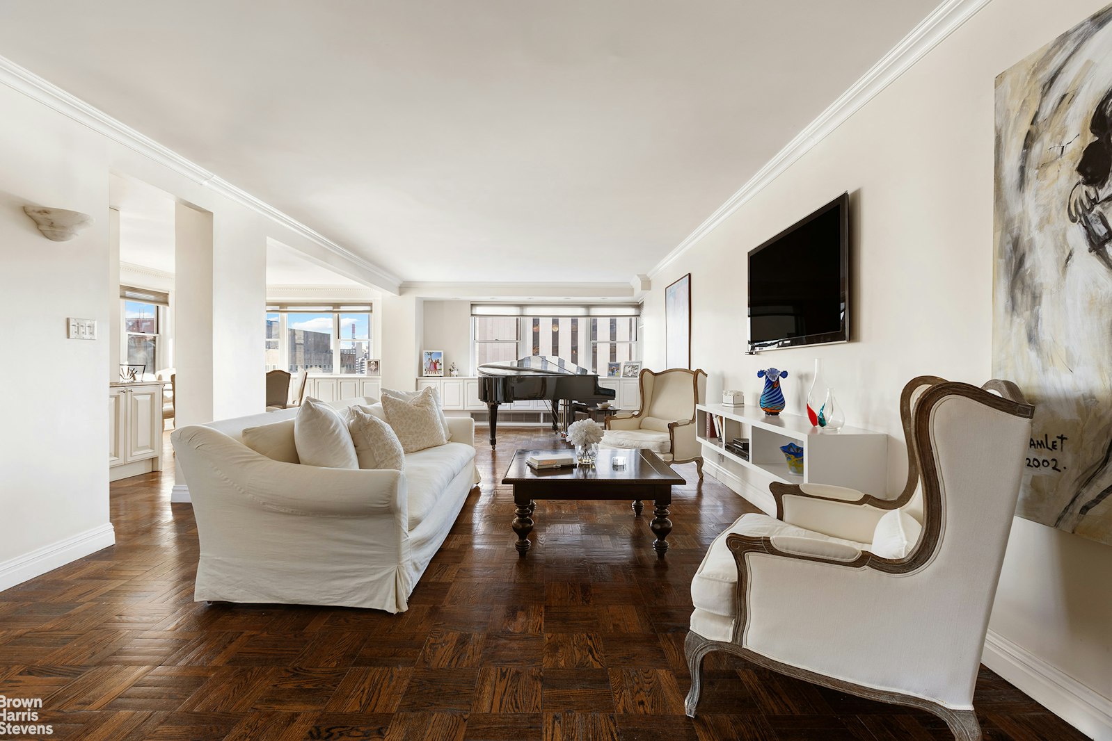 a living room with furniture floor and a flat screen tv