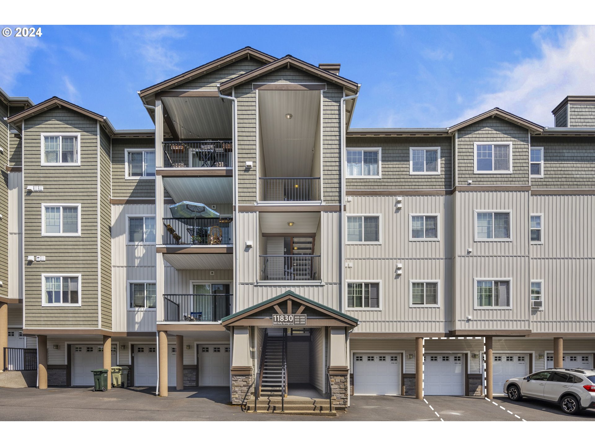 a front view of a residential apartment building with a yard