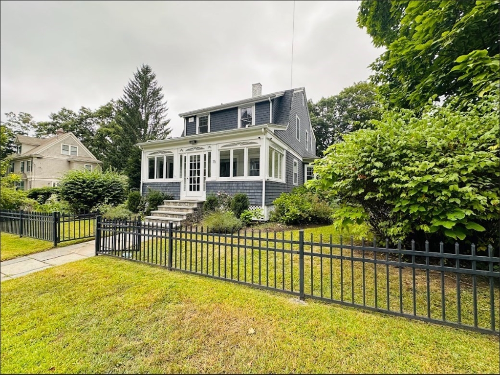 a view of a house with a wooden deck