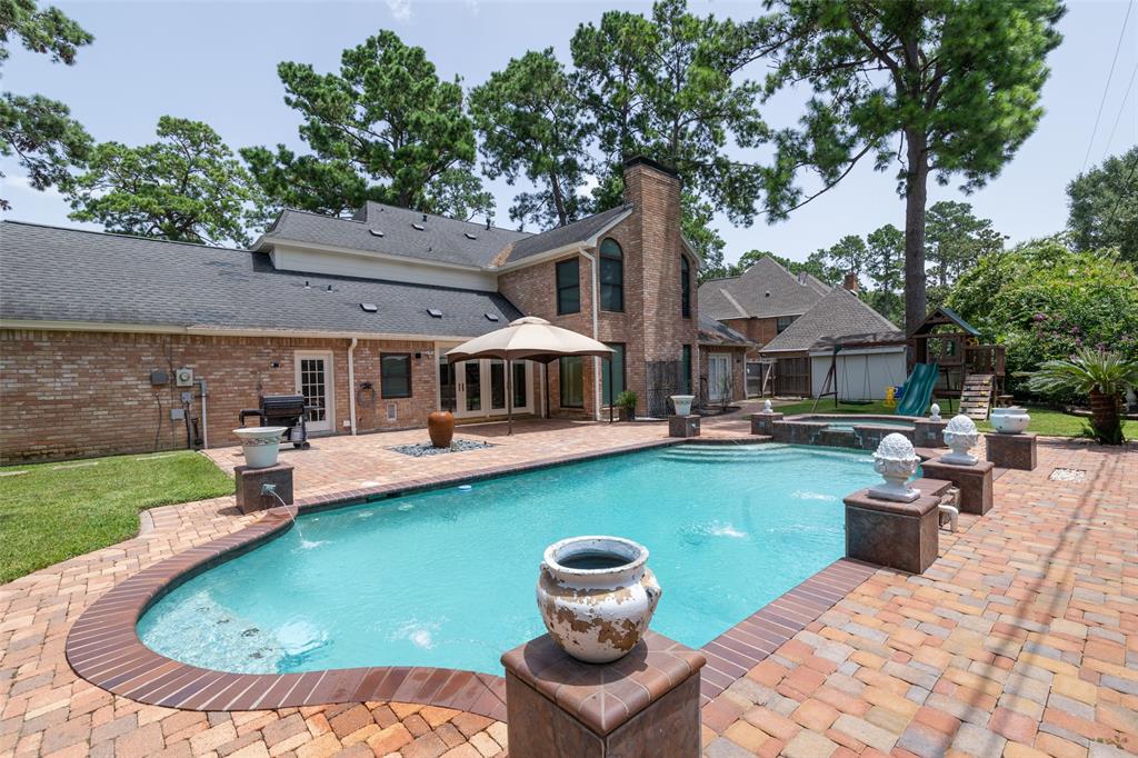 a view of a house with a yard patio and swimming pool