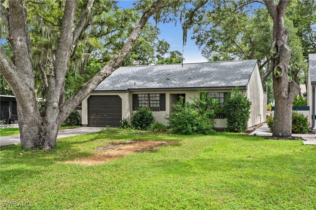 a front view of house with yard and green space