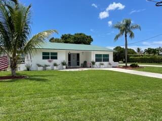 a front view of house with yard and outdoor seating