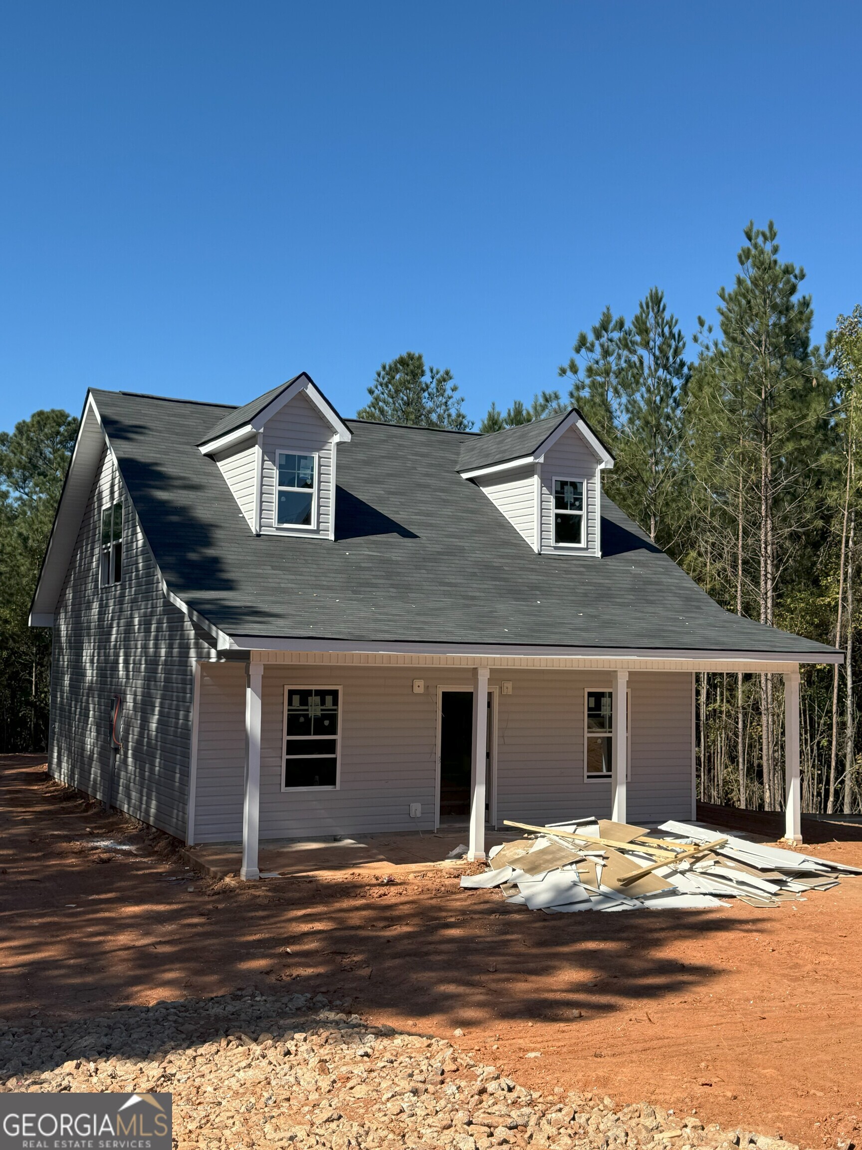 a front view of a house with a road