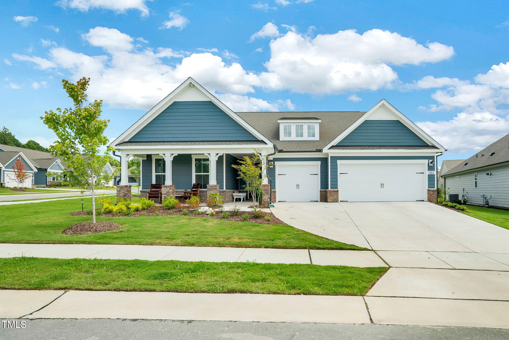 a front view of a house with a yard and porch