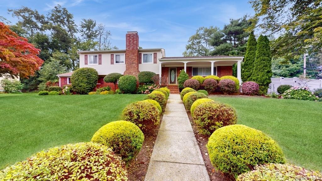 a front view of a house with garden