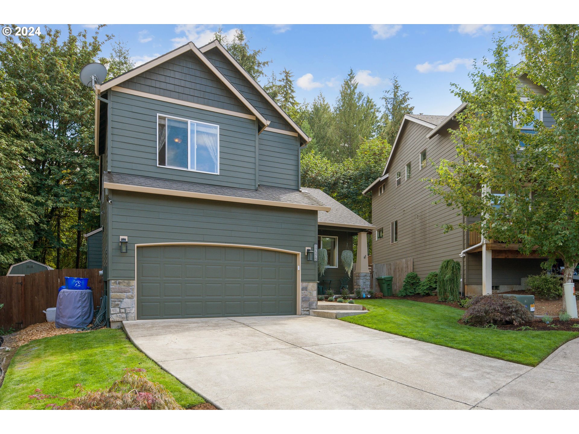 a front view of a house with a yard and a garage