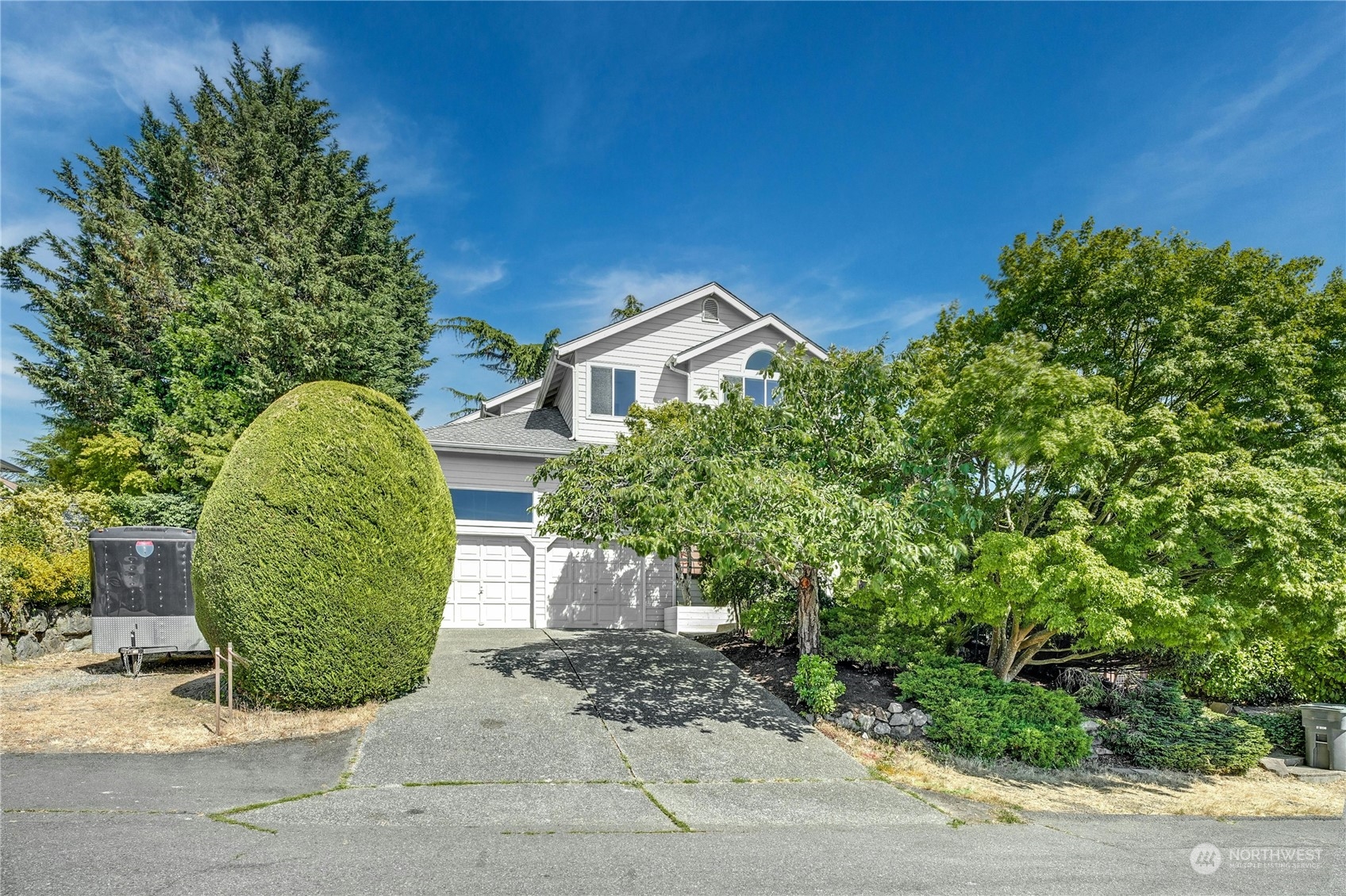 a front view of a house with a garden